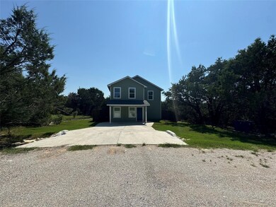 Traditional home with a front lawn and a porch