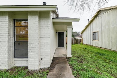 Property entrance featuring brick siding