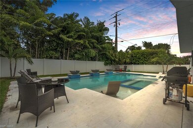 Pool at dusk with a patio area, area for grilling,