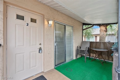 Doorway to property with stucco siding and screene