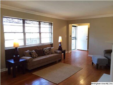 Large windows in living room and hardwood flooring