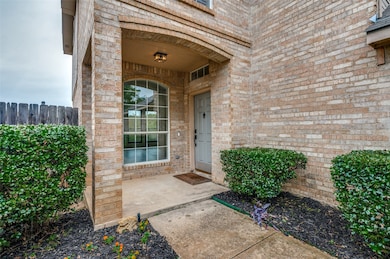 Property entrance featuring brick siding