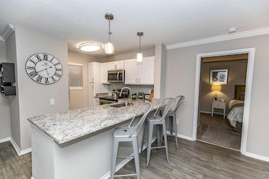 Kitchen featuring kitchen peninsula, appliances wi