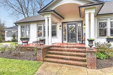 Beautiful curb appeal with front porch, side patio