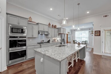 Kitchen featuring crown molding, a center island w
