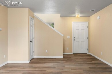 Empty room with light wood-style floors and baseboards