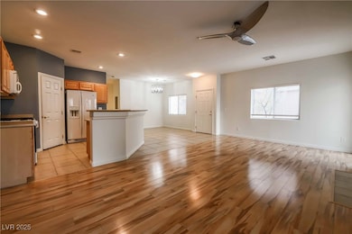 Kitchen featuring white appliances, light wood-sty