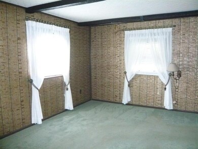 Living room with newer carpet.