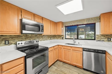 Kitchen with stainless steel appliances, a sink, o