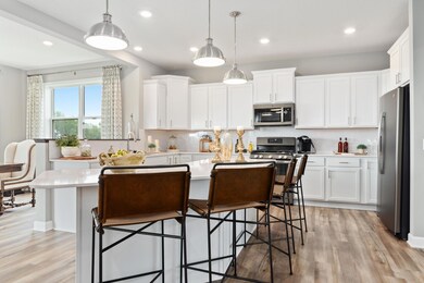 Be a part of the conversation from the kitchen as guests relax in the dining and great rooms.  Photo is of a previously built home, colors and finishes may vary.