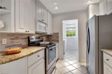 Kitchen featuring tasteful backsplash, light tile 