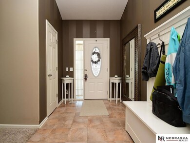 Tiled entry with Vaulted Ceilings Entry with Storage