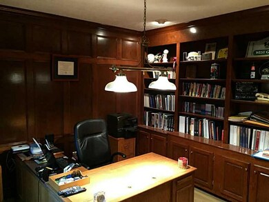 Den. The den has intricate custom wood trim with a