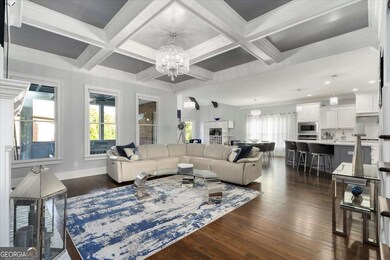 A large, Open Family Room received guests with Coffered Ceiling, Custom Built-Ins and Fireplace.