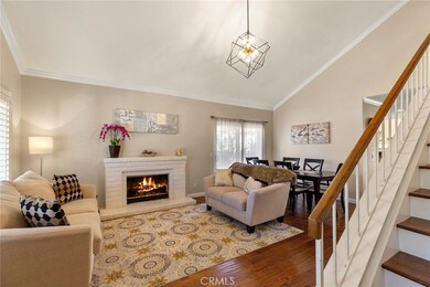 Bright, open living and dining rooms with romantic fireplace, and custom wood staircase