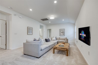 Living room with light colored carpet, recessed l