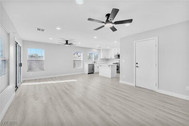 Unfurnished living room featuring visible vents, l