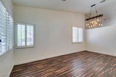 Unfurnished room with dark wood finished floors, b