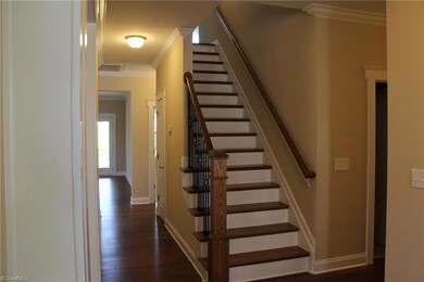 Stairs have Wrought Iron Rails and Hardwood Treads