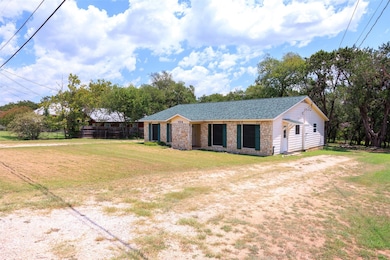View of front of property featuring stone siding,