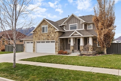 Craftsman house with board and batten siding, a shingled roof, concrete driveway, covered porch, and stone siding