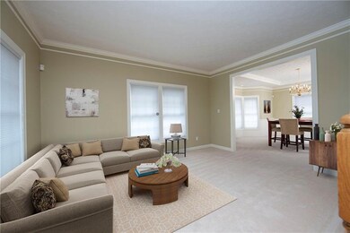 Formal living room with crown molding and open to 