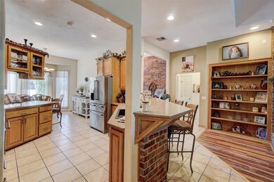 Kitchen with light stone counters, light tile patt
