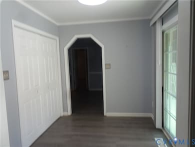 Corridor with wood finished floors and arched walkways