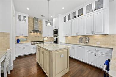 Kitchen with stainless steel appliances, wall chi