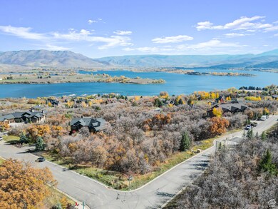 Water view with a mountain backdrop and nearby suburban area