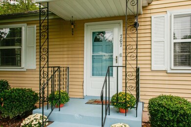 Covered front porch with tranquil robins egg blue front door.