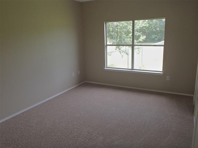 Carpeted empty room with baseboards