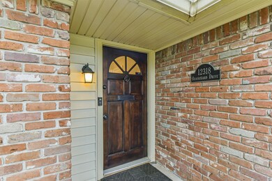 Charming entrance with a classic wooden door, bric