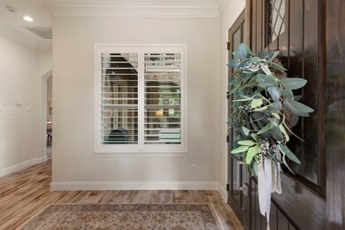 Step inside through a welcoming entrance offering a view of the interior courtyard.