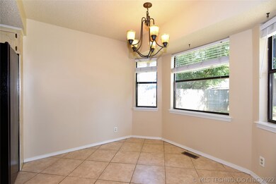 Spacious Eating Area in Kitchen has tile floor.
