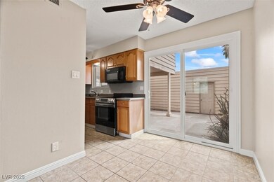 Kitchen featuring baseboards, black microwave, a t