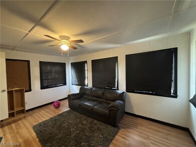 Living room with light wood-type flooring and ceiling fan