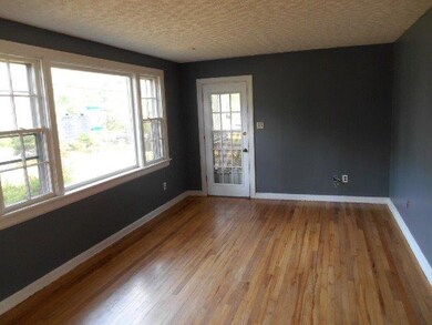 The living room has ample lighting and direct acce