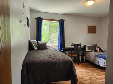 Bedroom featuring light hardwood / wood-style floo