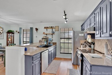 Kitchen with electric stove, under cabinet range h