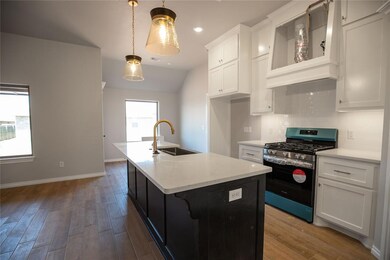 Kitchen with sink, stainless steel range with gas 