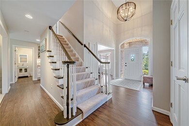 Soaring foyer with gorgeous new light fixture welc