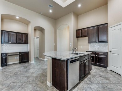 Sit down desk in kitchen, lots of cabinets for storage