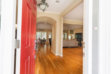 Foyer entrance with hardwood flooring and crown mo