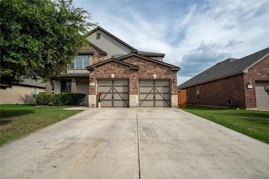 View of front facade with a garage, a front yard,
