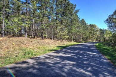 View of asphalt road featuring a view of trees