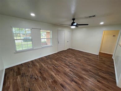 Spare room featuring dark wood-type flooring, recessed lighting, and a ceiling fan