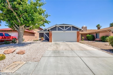 View of front of home featuring driveway, a chimne