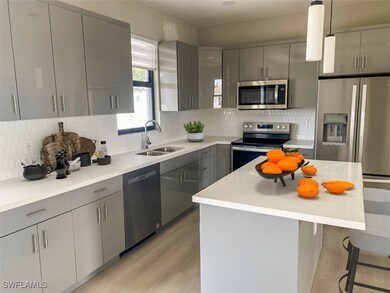 Kitchen with stainless steel appliances, gray cabi
