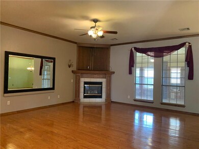 Large living  area with crown molding, tall ceilin